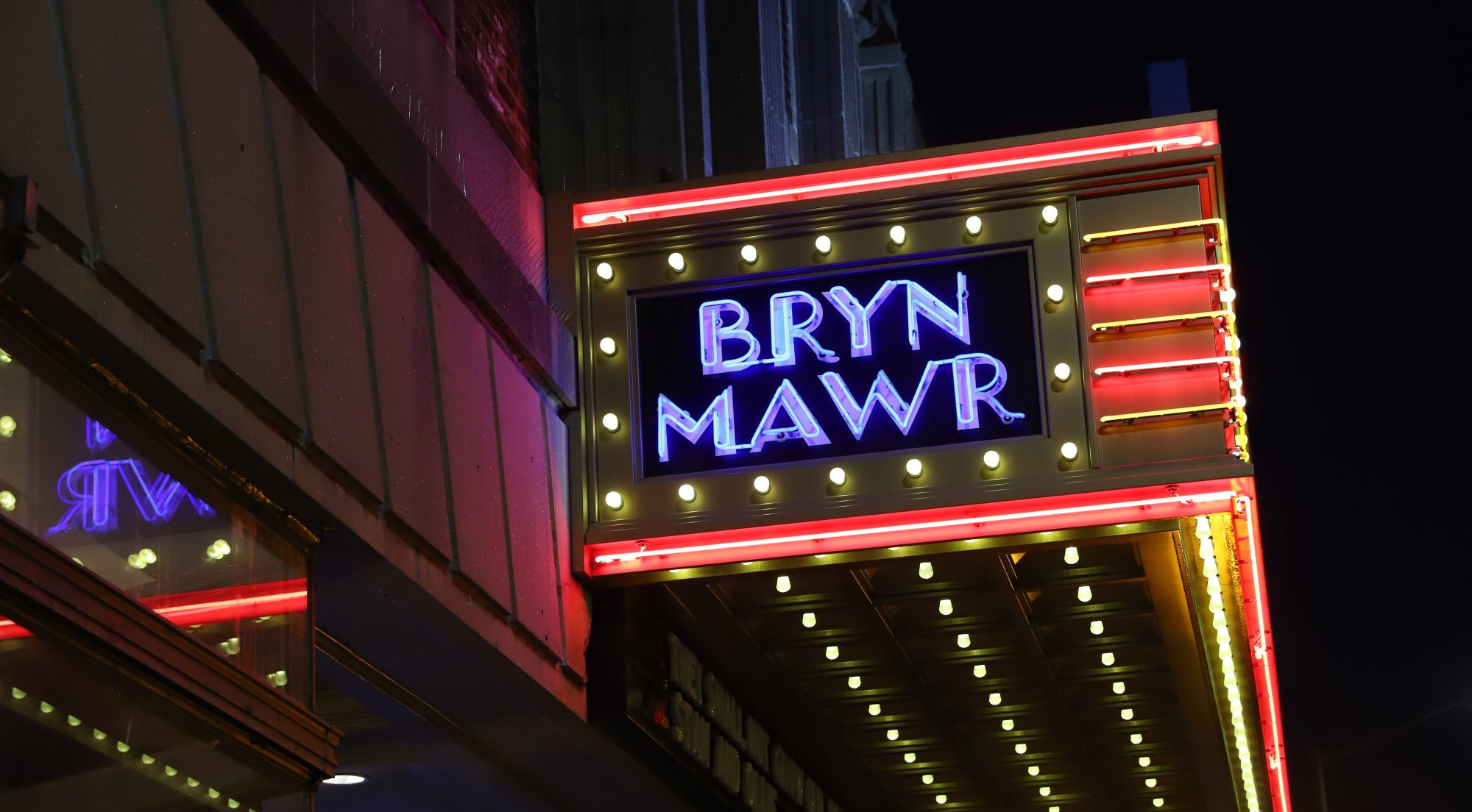 Bryn Mawr Film Institute marquee lit up at night, view from the side.